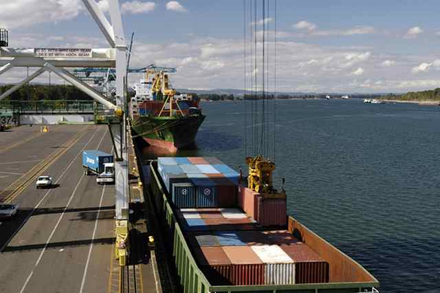 Containers are unloaded from a river barge at Terminal 6 Port of Portland.